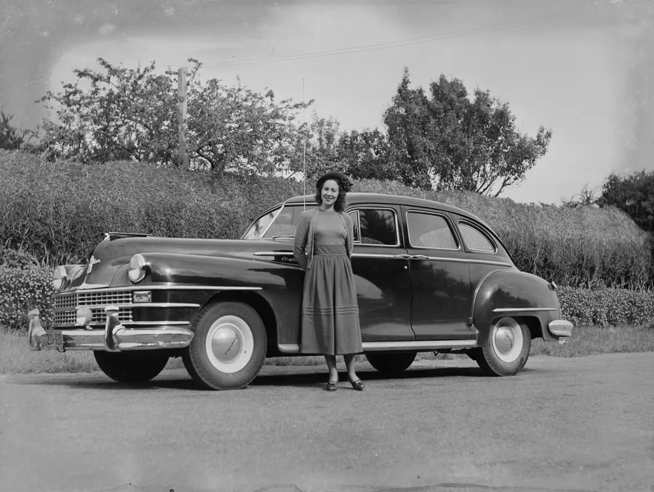 (Portrait of woman in front of car)
